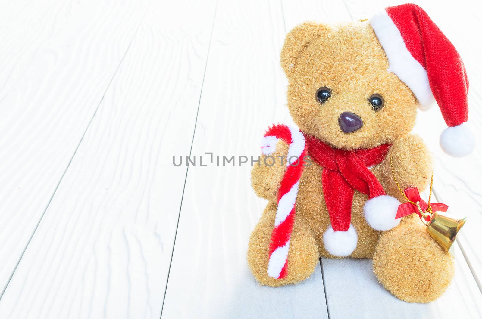 A Santa Bear Doll has already to celebrate the christmas and new year festival with wood background.