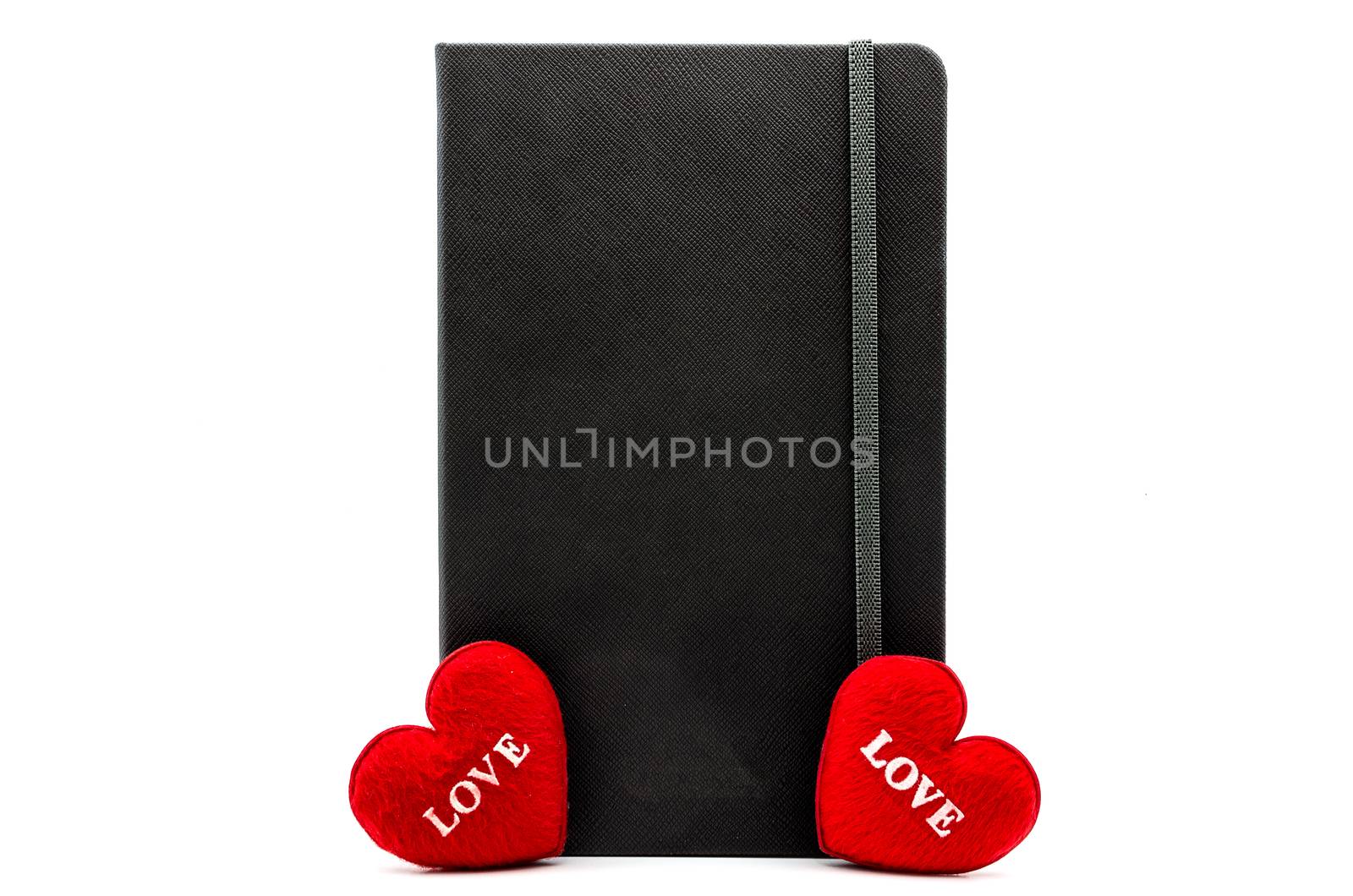 A Black Book has between the two red heart with word is LOVE for valentine's day festival on white isolated.