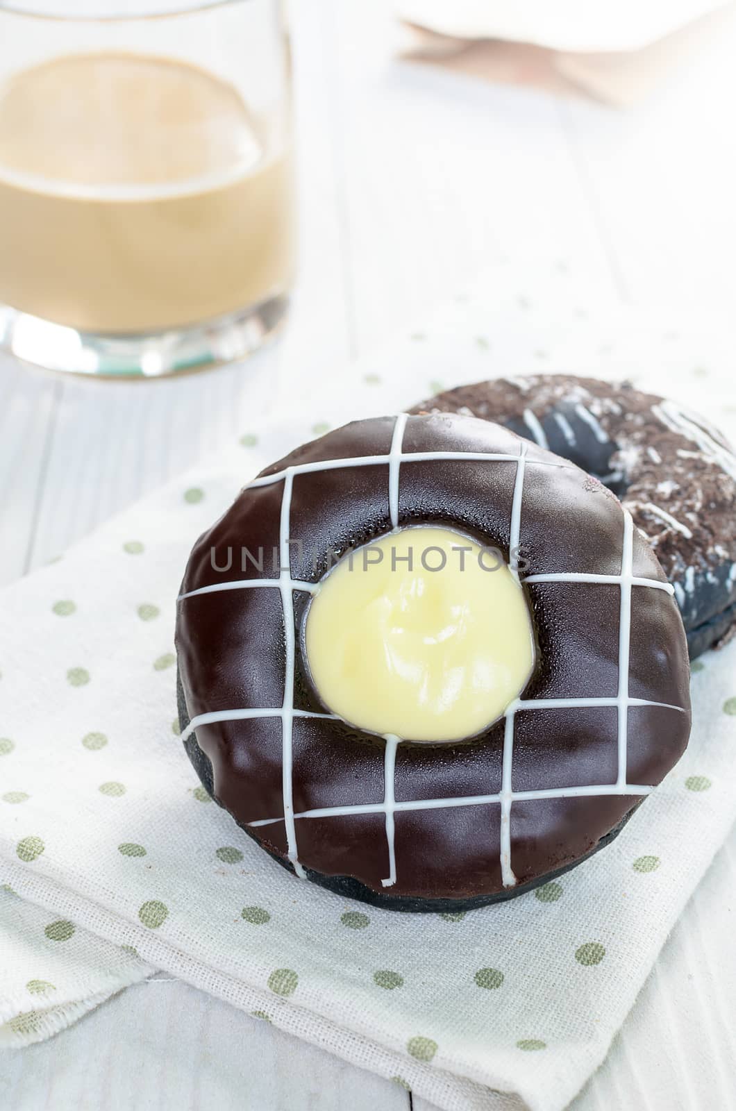 Chocolate Donuts and Coffee on the white wood ready to served in the morning and dessert time.