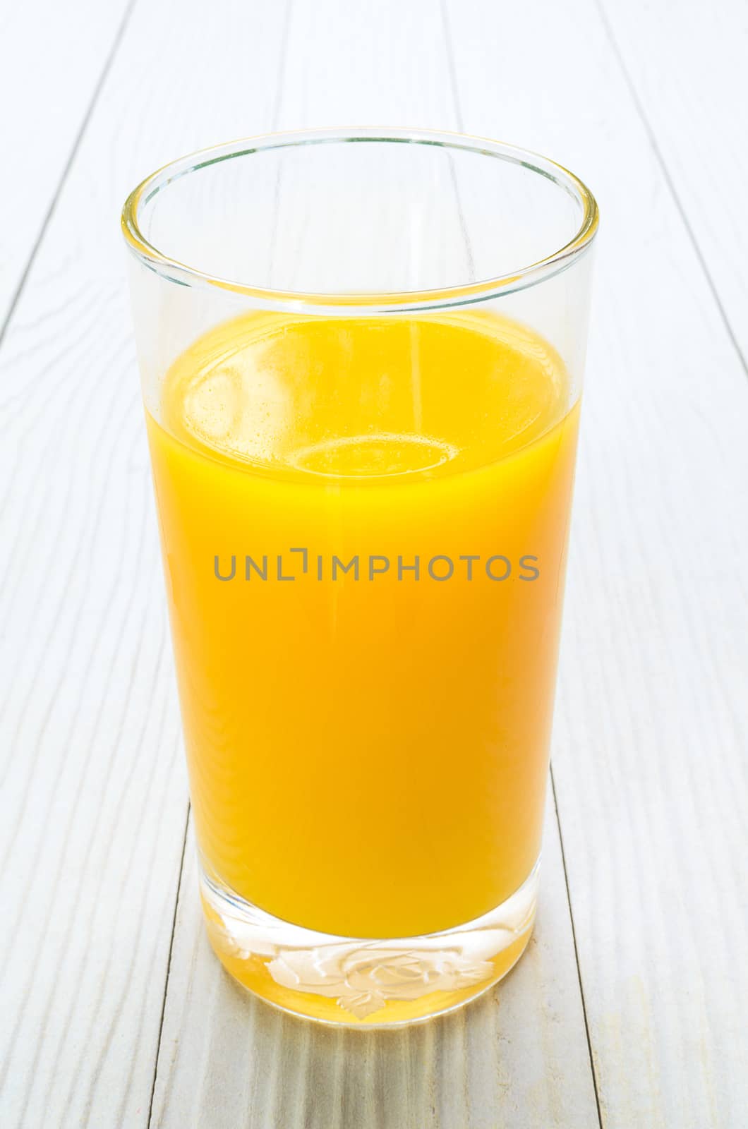 The Freshly Squeezed Orange juice on the white wood table
