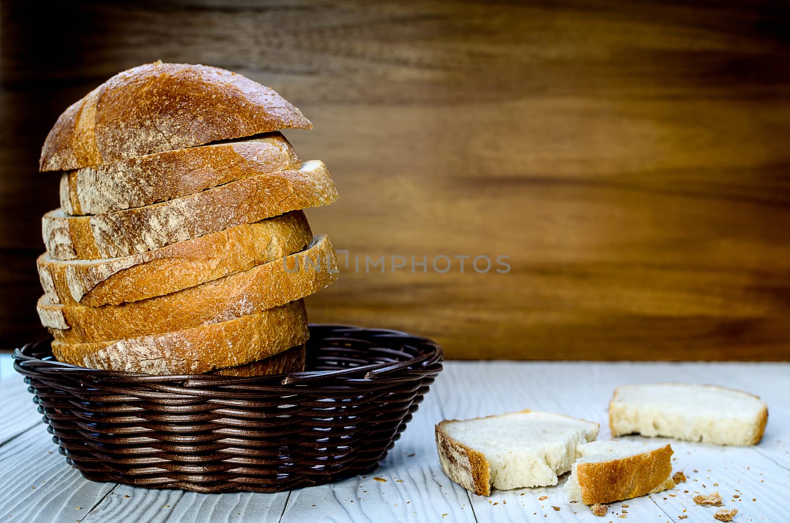 A Sliced Pain De Campagne Au Levain Bread in the wicker brown wood basket bowl.