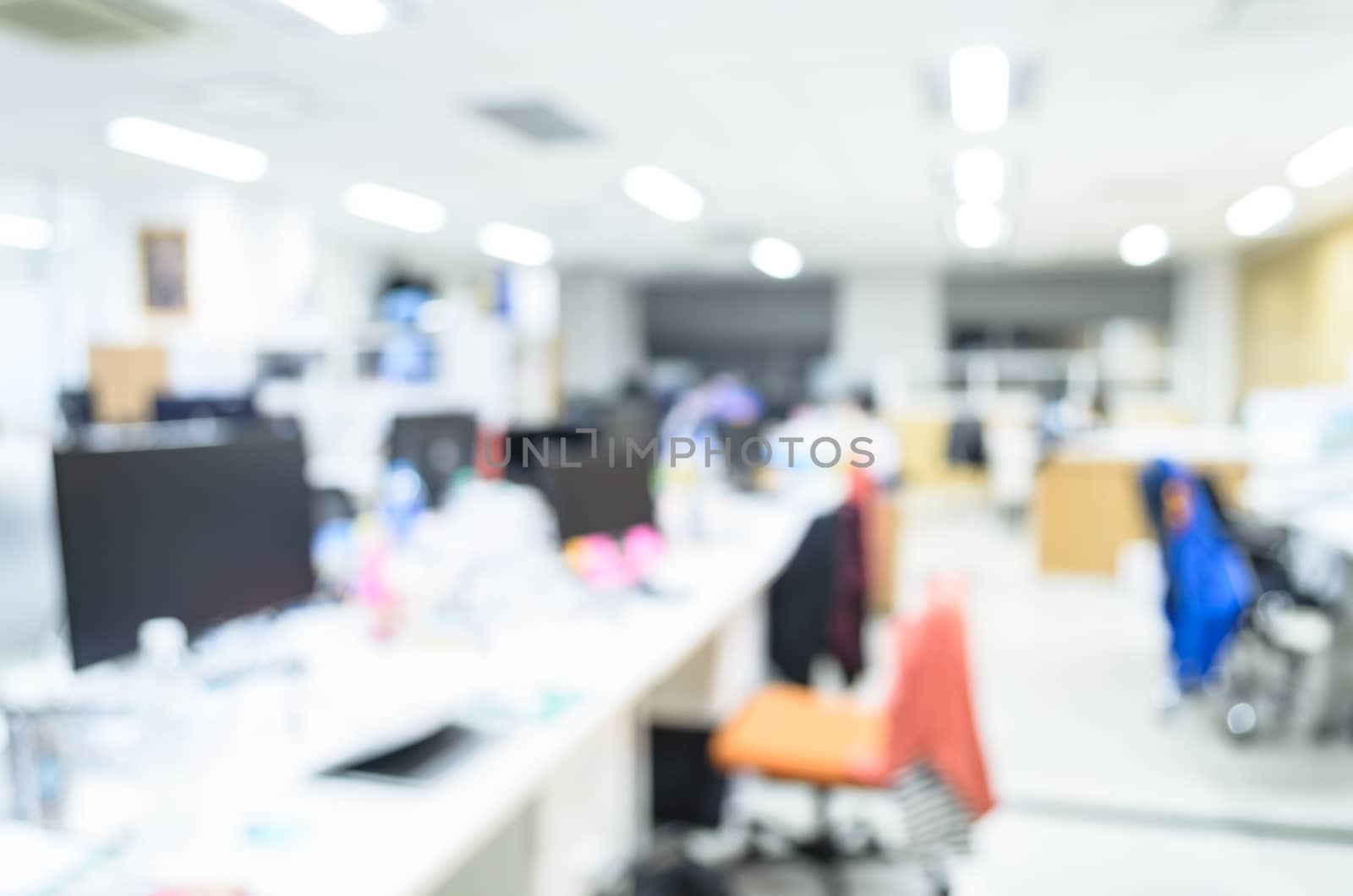 office work room blurred in the workplace. Table top and blurred Office of Background blur table work in office with computer.Abstract background of office, shallow depth of focus,monitor