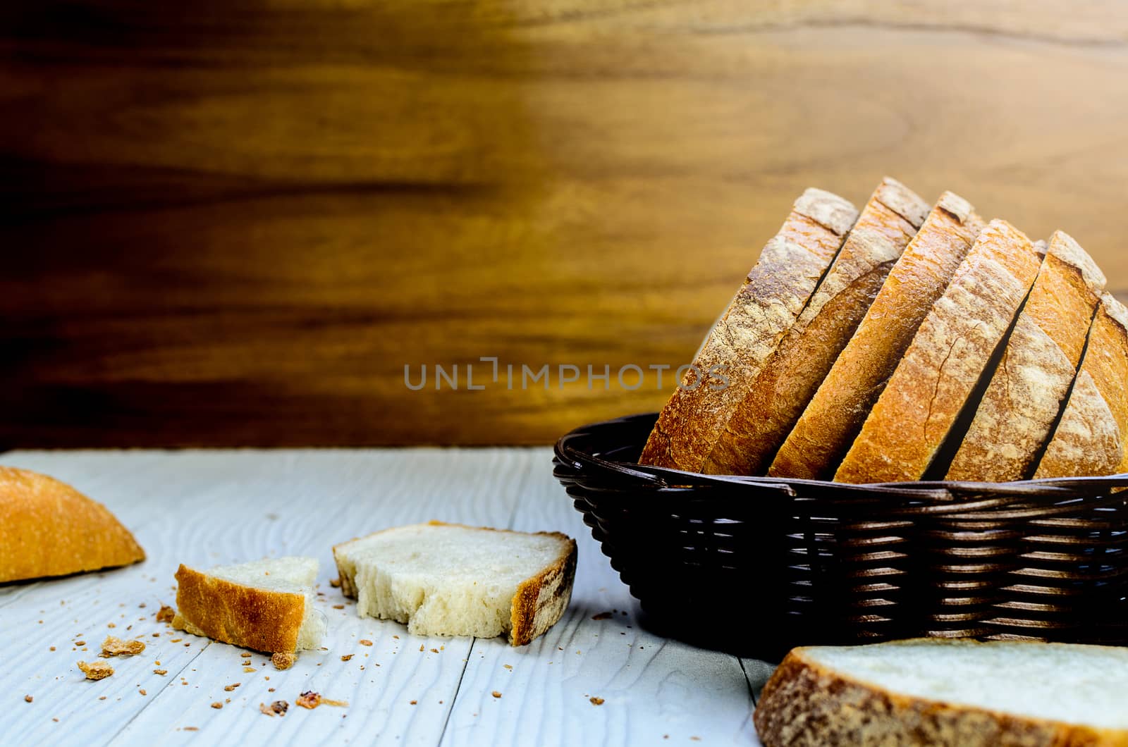 A Sliced Pain De Campagne Au Levain Bread in the wicker brown wood basket bowl.