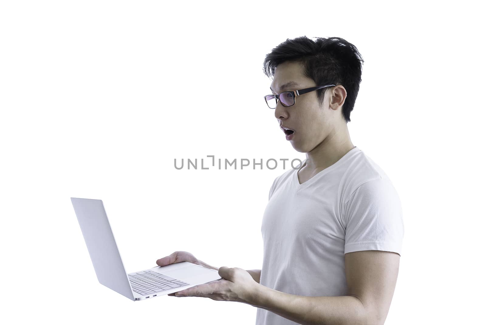 Asian handsome man with white shirt and orange eyeglasses has feeling like a really surprise and shock when holding and working computer laptop isolated on white background and clipping paths.