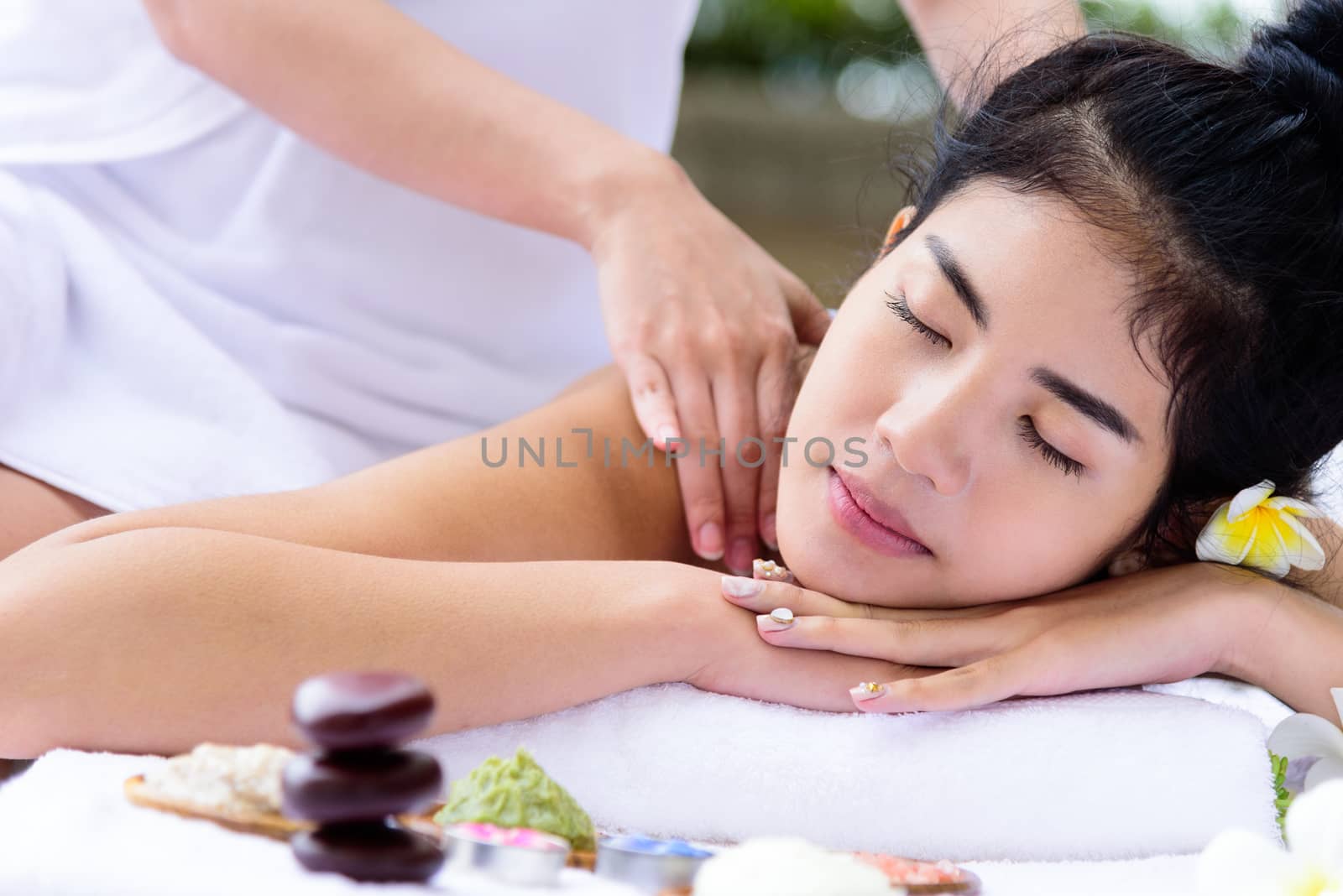 Portrait of beautiful asian people with close up view and close up eyes and having hand massage in spa salon. Beauty, healthy, spa and relaxation concept.