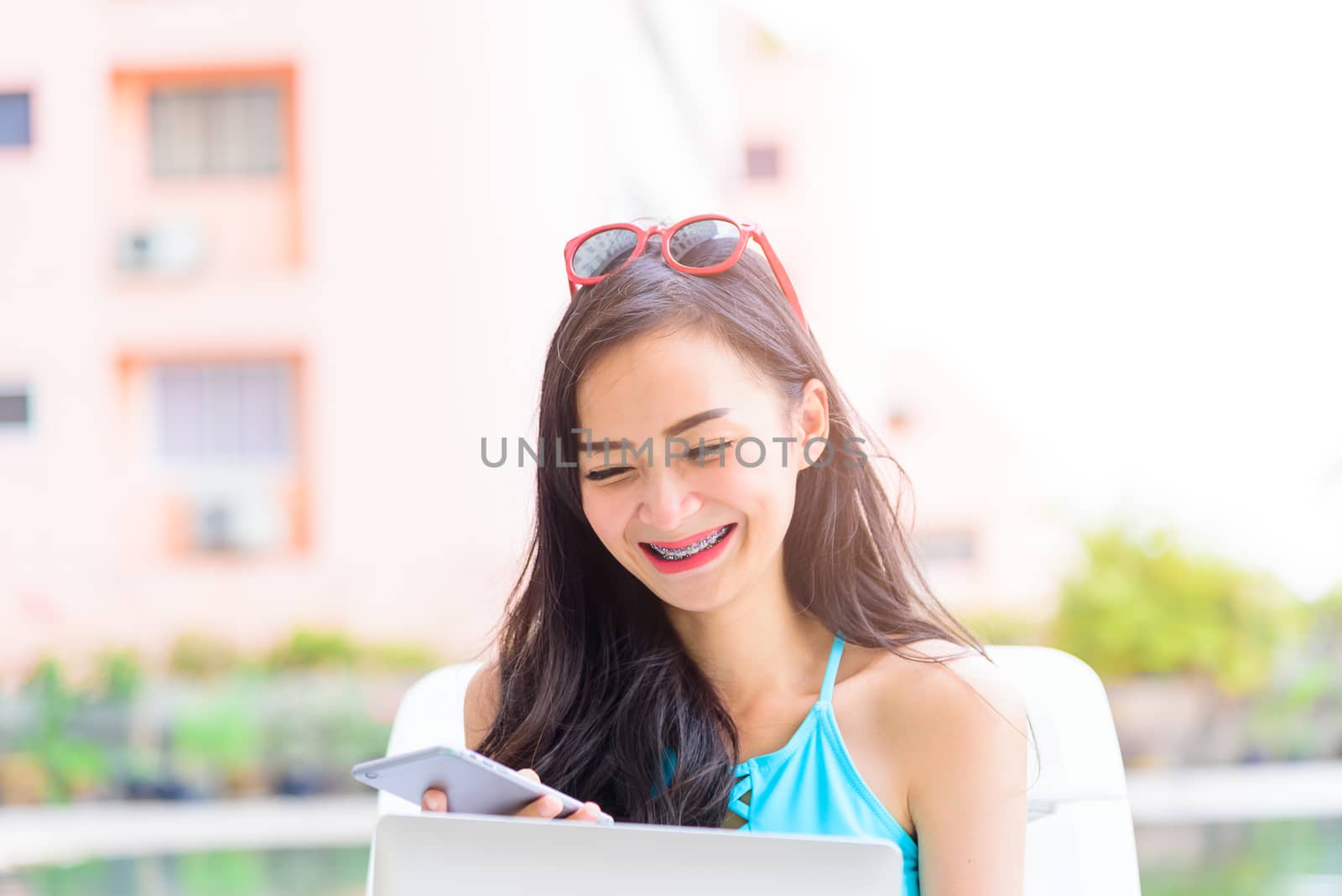 Sexy asian woman has working with laptop in the evening and suns by animagesdesign