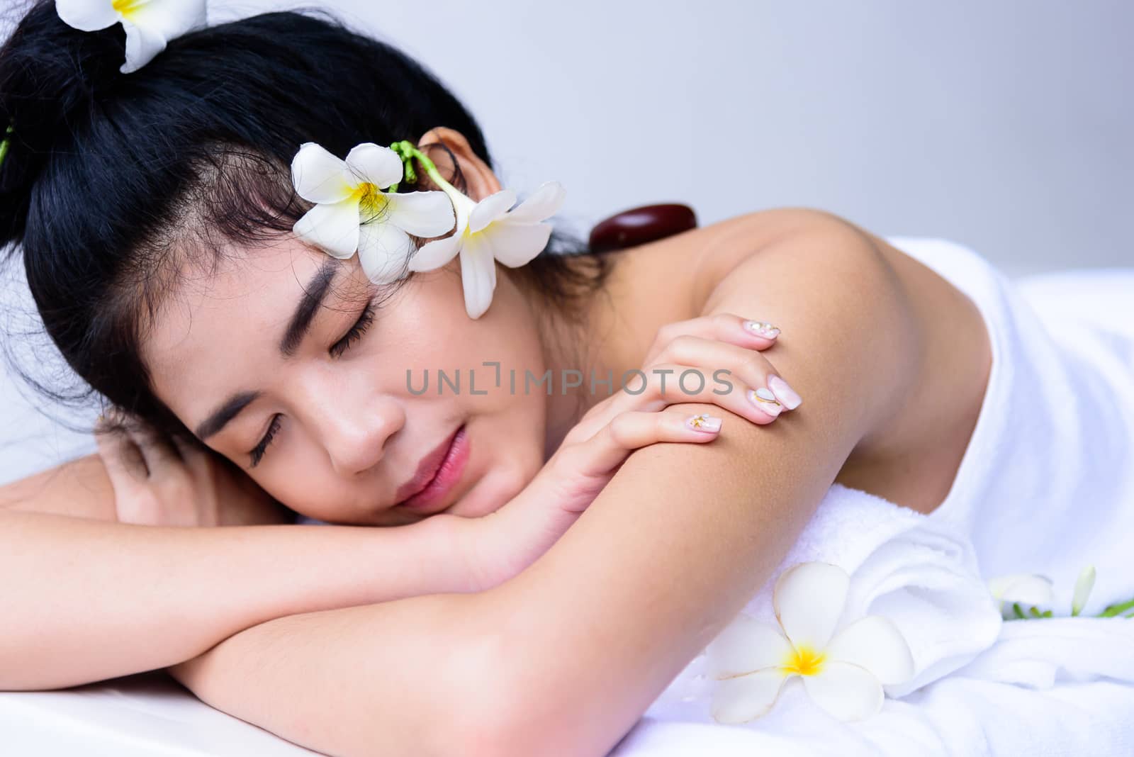 Portrait of beautiful asian people with close up view and close up eyes and having hand massage in spa salon. Beauty, healthy, spa and relaxation concept.