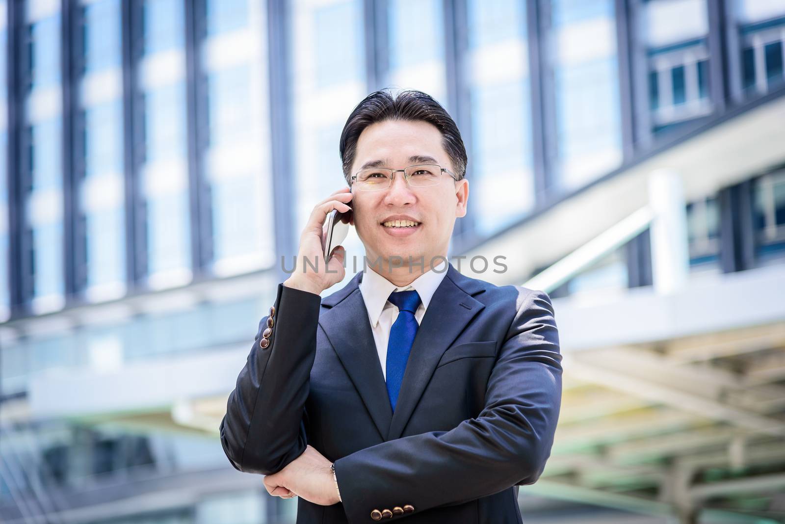 The asian businessman has working on mobile with happy.