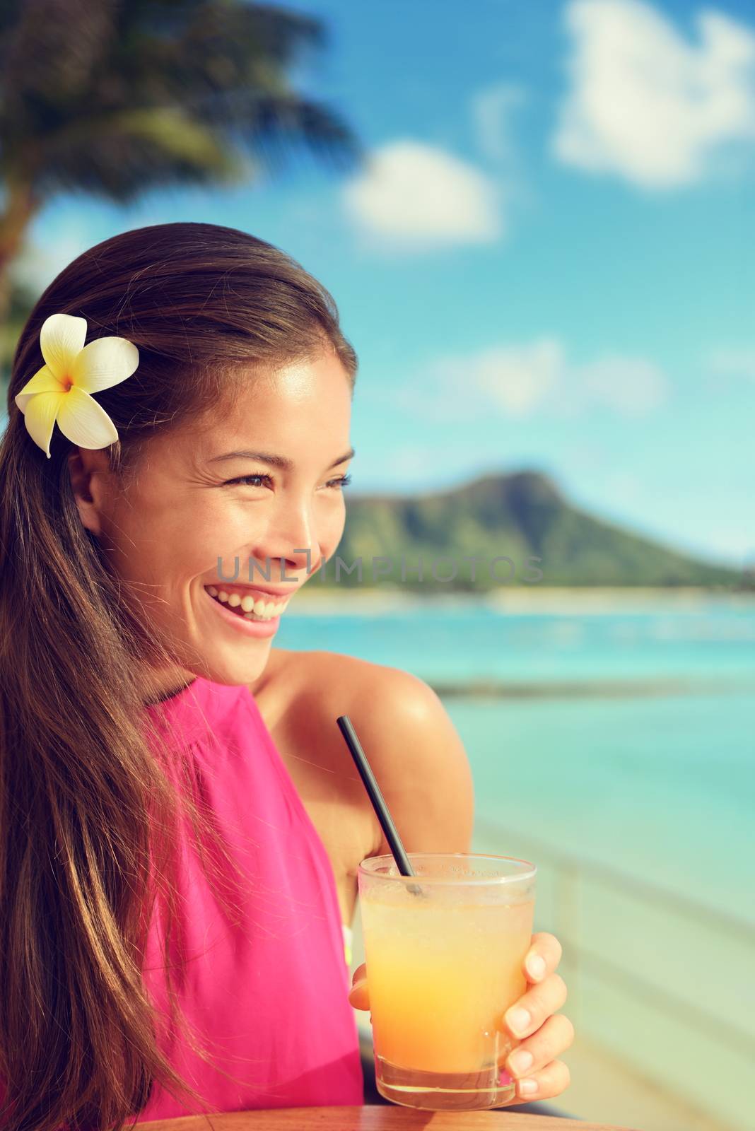 Cocktail woman drinking mai tai drink at outdoor bar on Waikiki beach, Honolulu, Oahu, Hawaii. Asian girl enjoying sunset evening, luxury travel lifestyle.