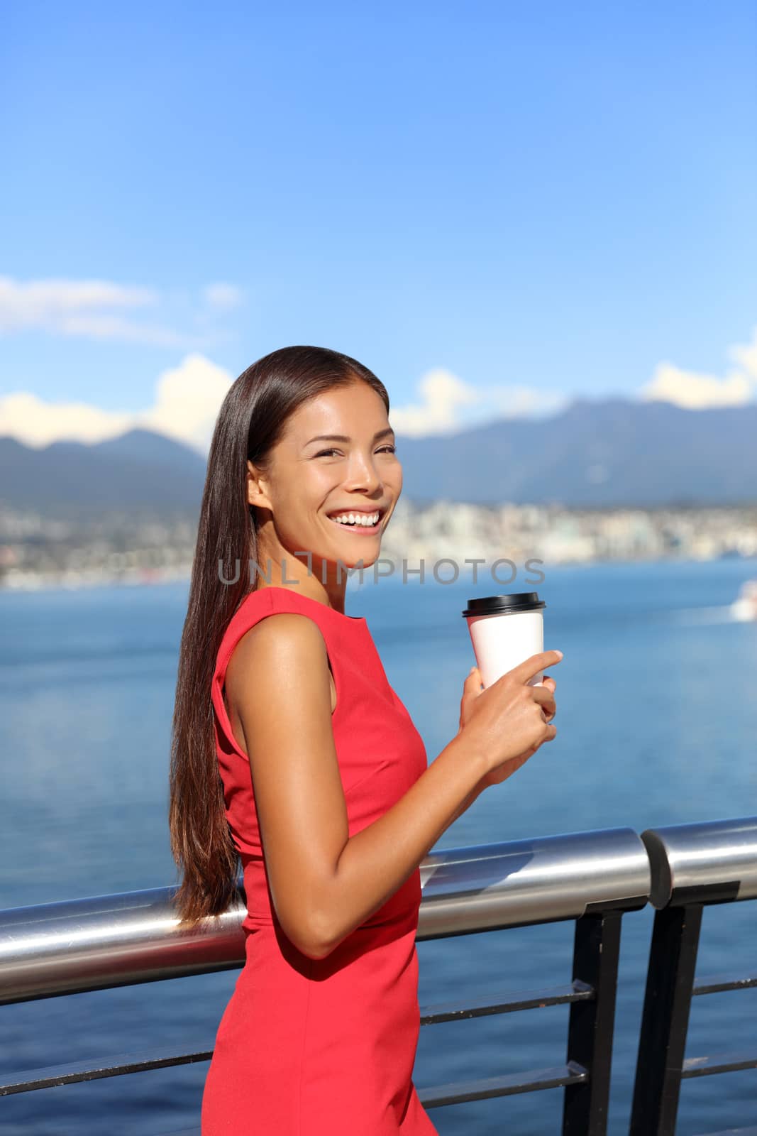 Happy multiethnic business woman enjoying her morning coffee at work break in beautiful nature view in vancouver city, downtown. Urban lifestyle, businesspeople working in coal harbour by Maridav