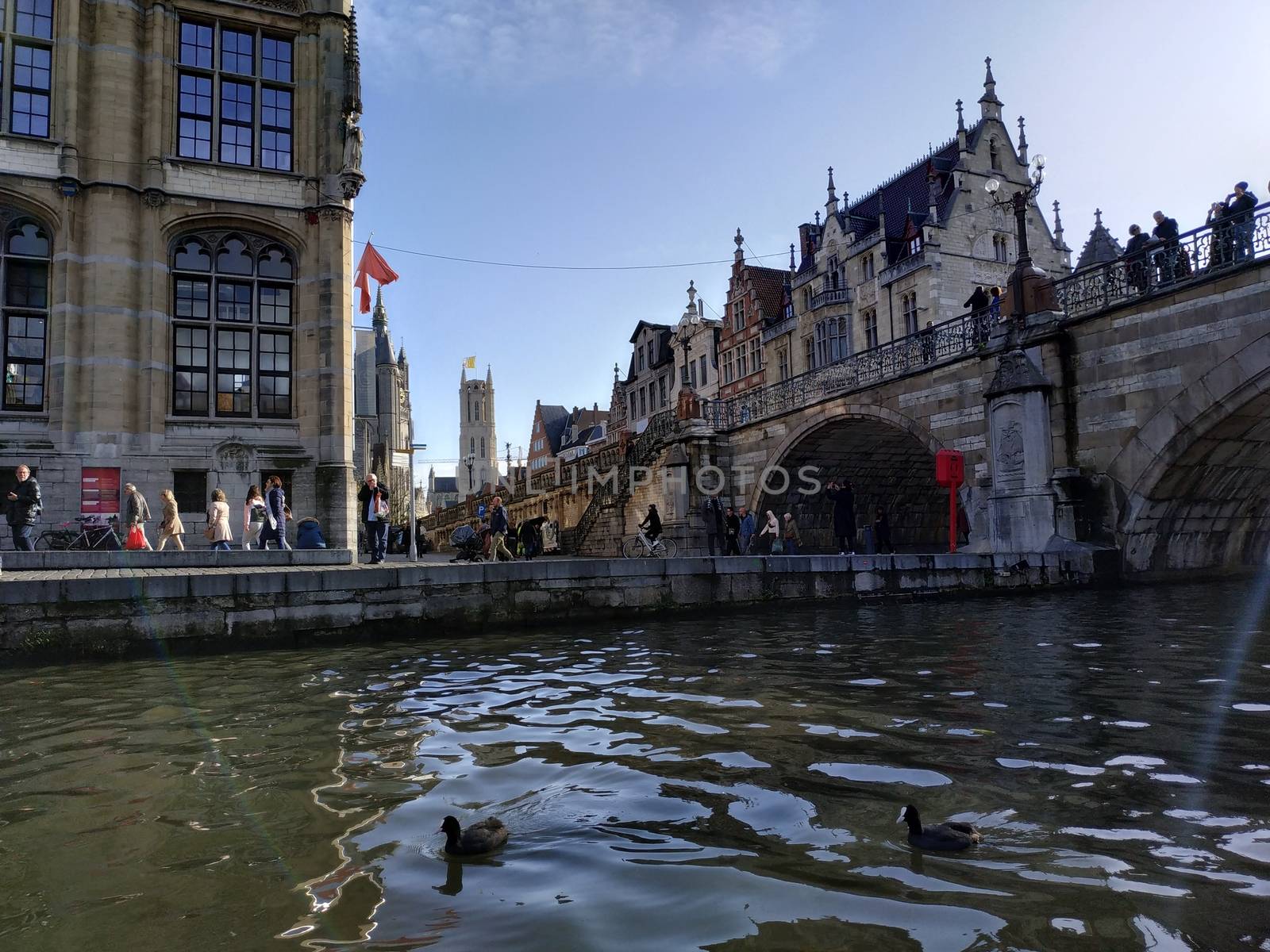 Ghent, Belgium - November 02, 2019: view on the streets and roads with tourists walking around by VIIIPhoto