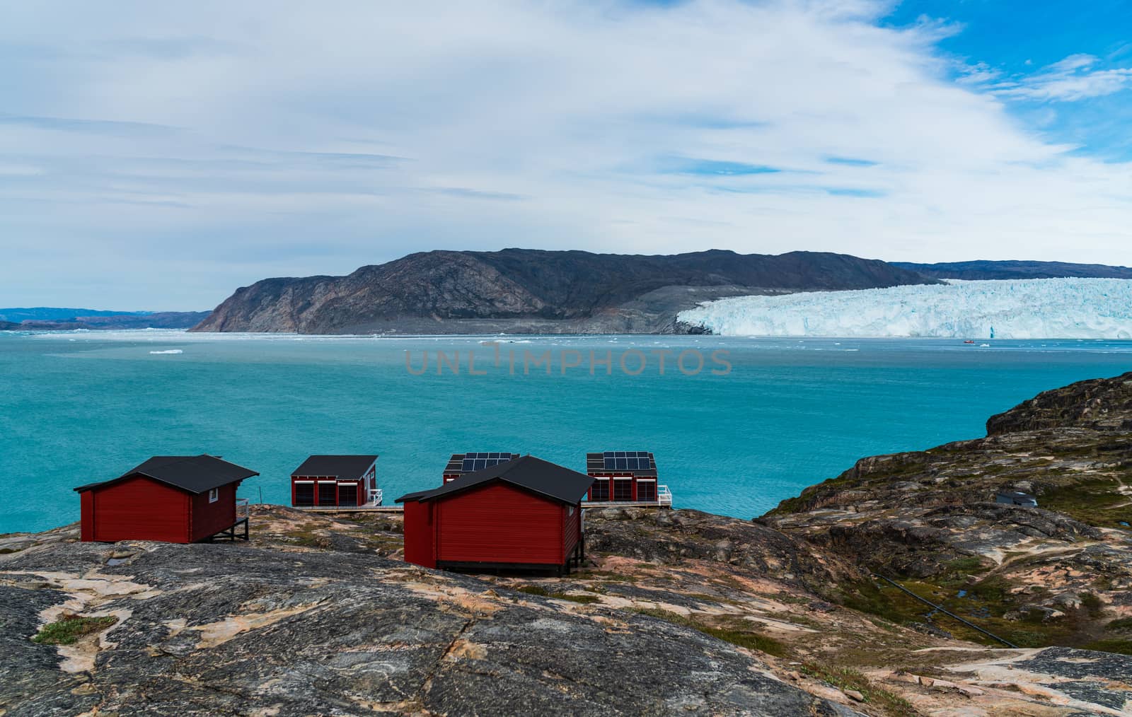 Greenland glacier nature landscape with famous Eqi glacier and lodge cabins by Maridav