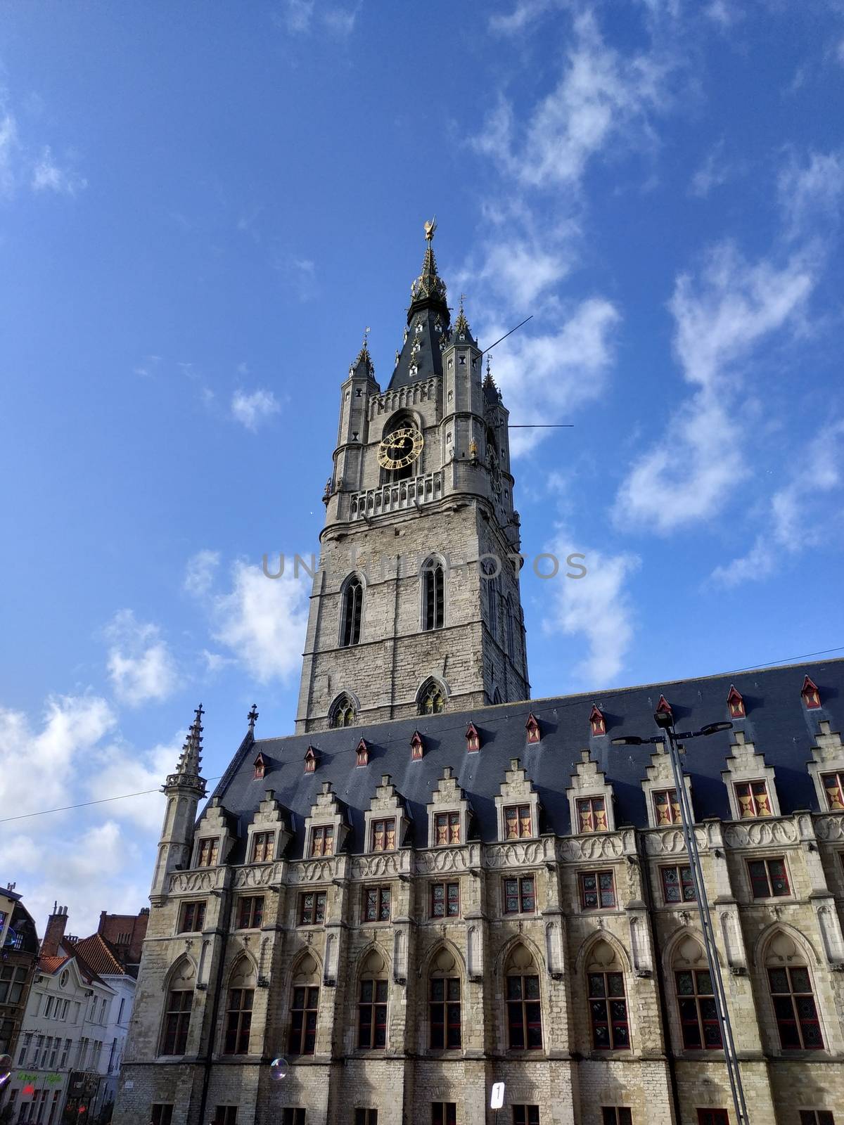 Ghent, Belgium - November 02, 2019: view on the streets and roads with tourists walking around by VIIIPhoto