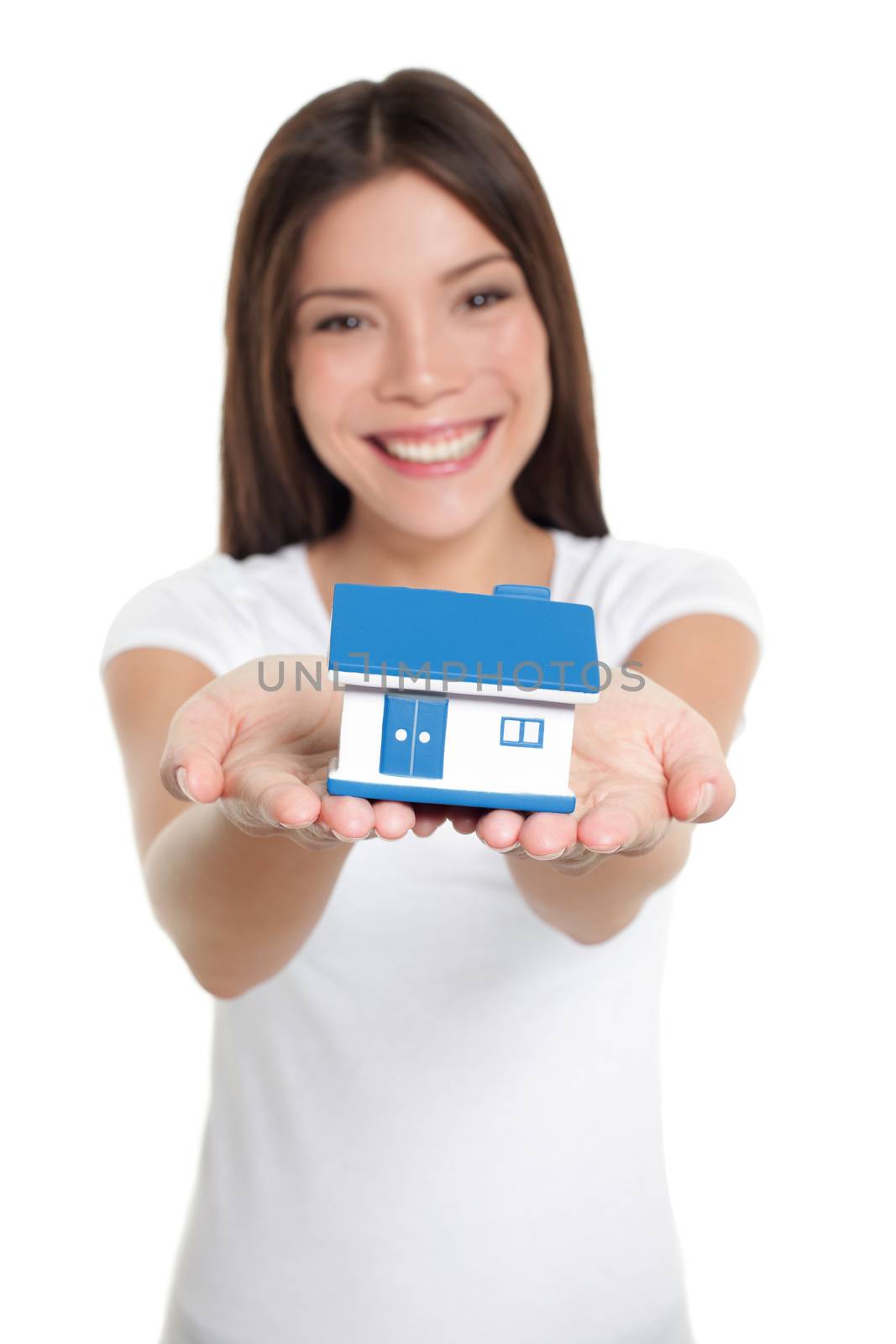 Home owner of first house holding small house toy on hands for real estate mortgage, loan, insurance concept.