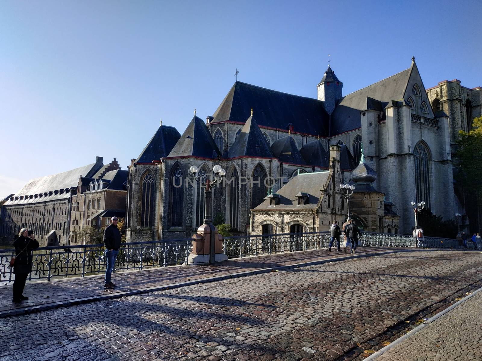 Ghent, Belgium - November 02, 2019: view on the streets and roads with tourists walking around by VIIIPhoto