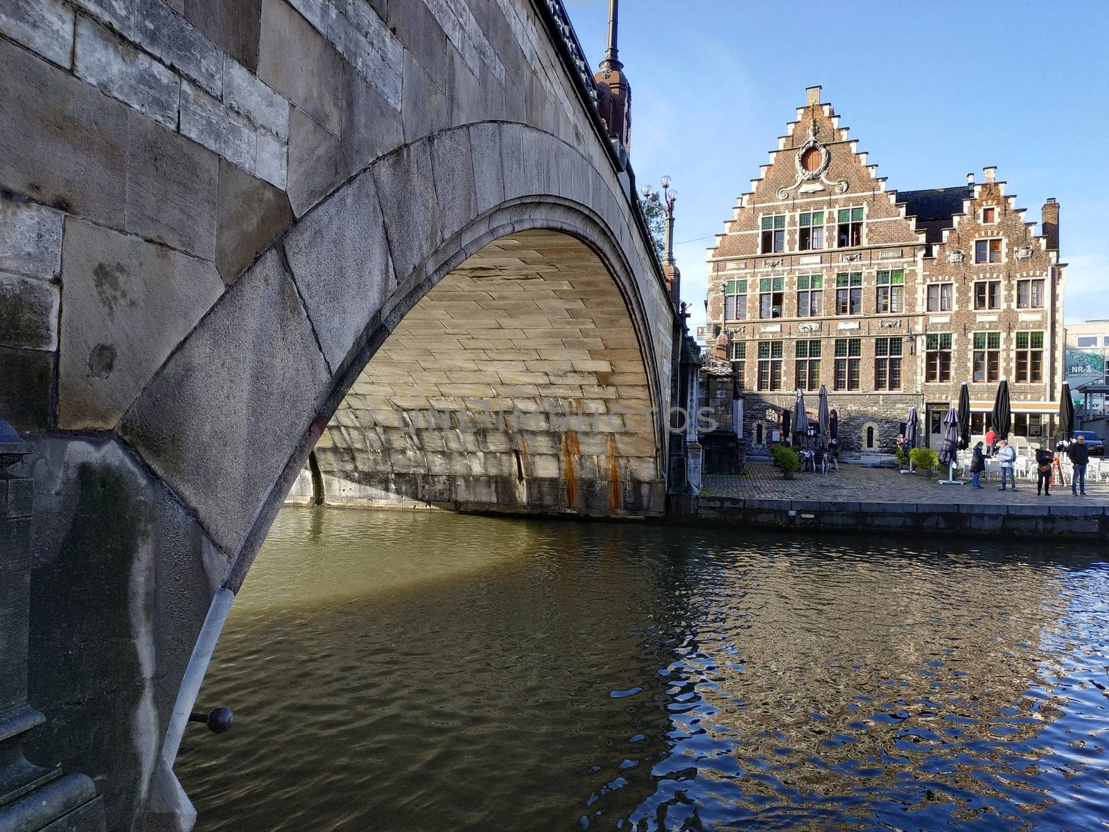 Ghent, Belgium - November 02, 2019: view on the streets and roads with tourists walking around by VIIIPhoto