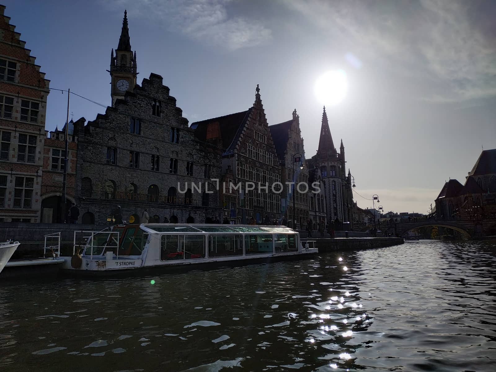 Ghent, Belgium - November 02, 2019: view on the streets and roads with tourists walking around by VIIIPhoto