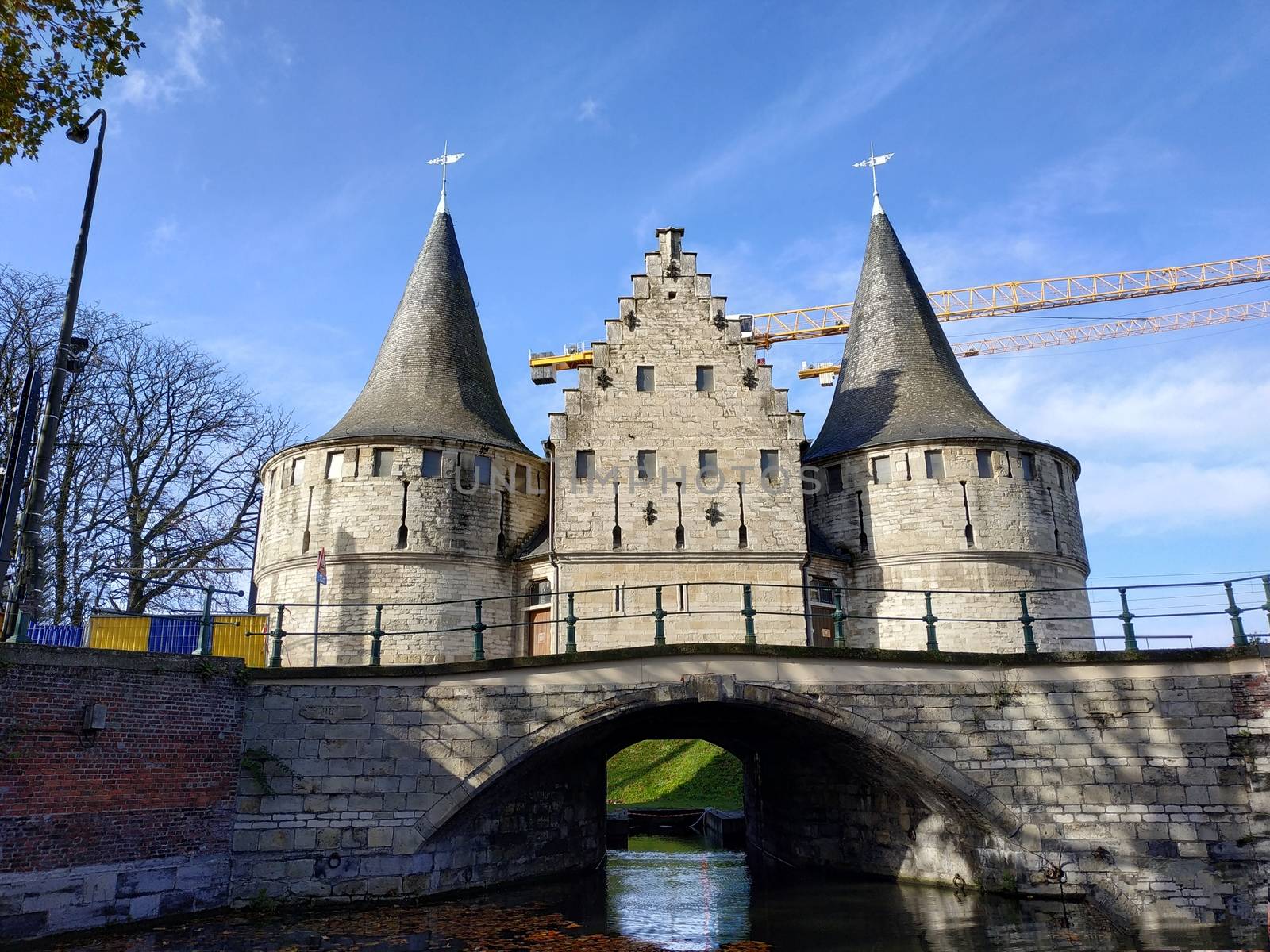 Ghent, Belgium casual view on the buildings streets and roads with tourists walking around by VIIIPhoto