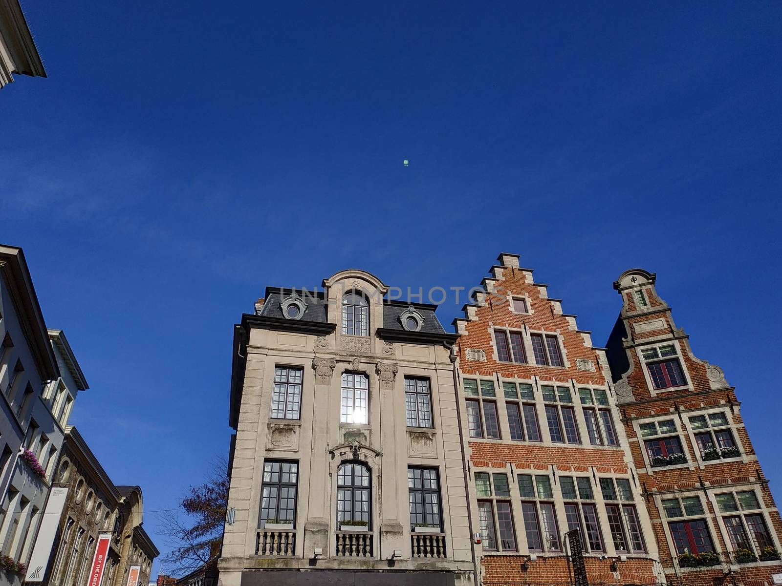 Ghent, Belgium casual view on the buildings streets and roads with tourists walking around by VIIIPhoto