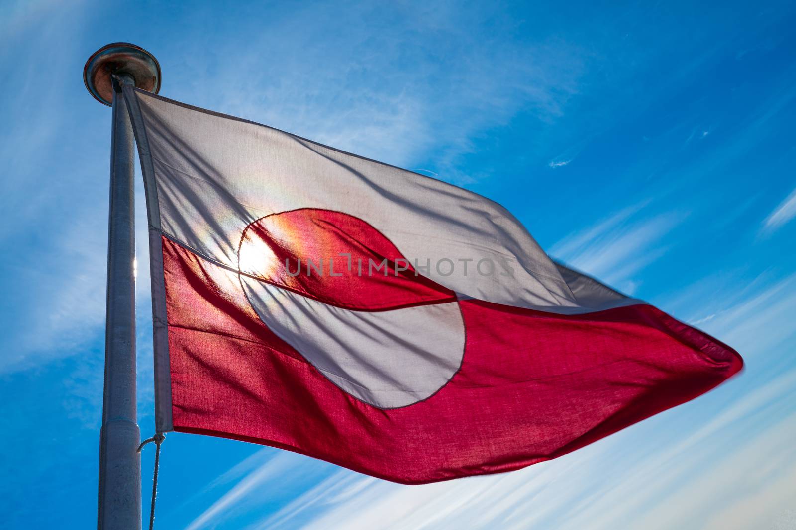 Greenland flag - Greenlandic flag against blue sky on Greenland by Maridav