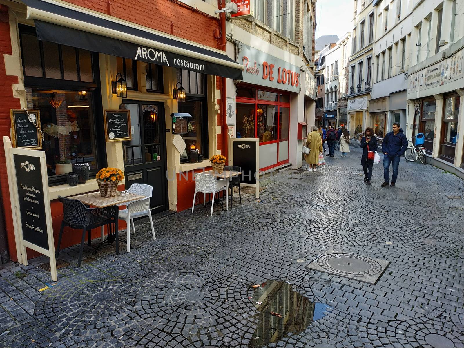 Ghent, Belgium - November 02, 2019: view on the streets and roads with tourists walking around by VIIIPhoto