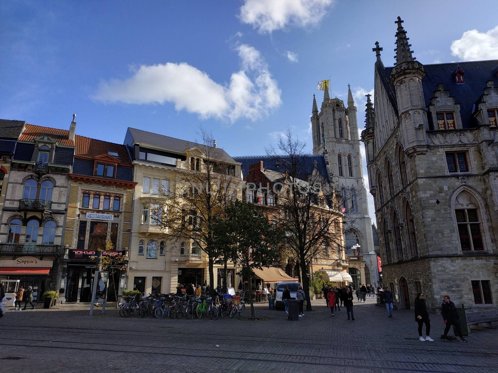 Ghent, Belgium - November 02, 2019: view on the streets and roads with tourists walking around by VIIIPhoto