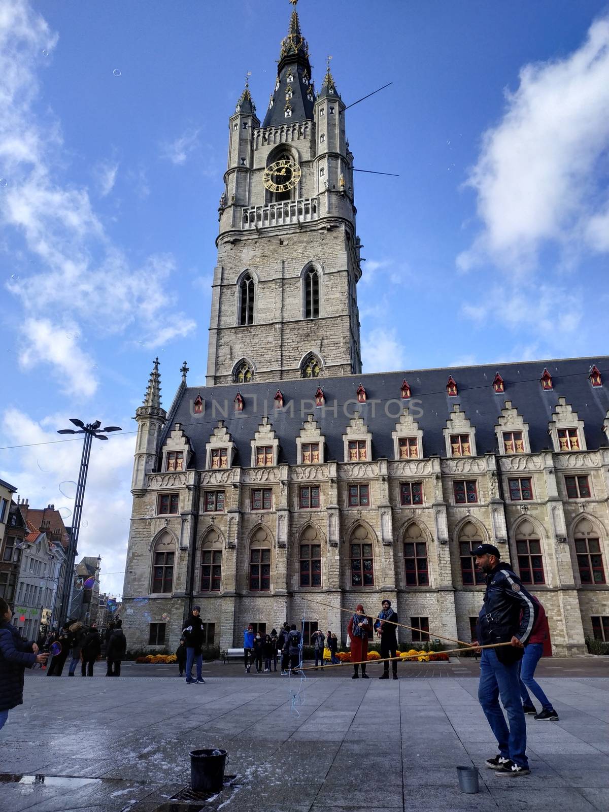 Ghent, Belgium - November 02, 2019: view on the streets and roads with tourists walking around by VIIIPhoto