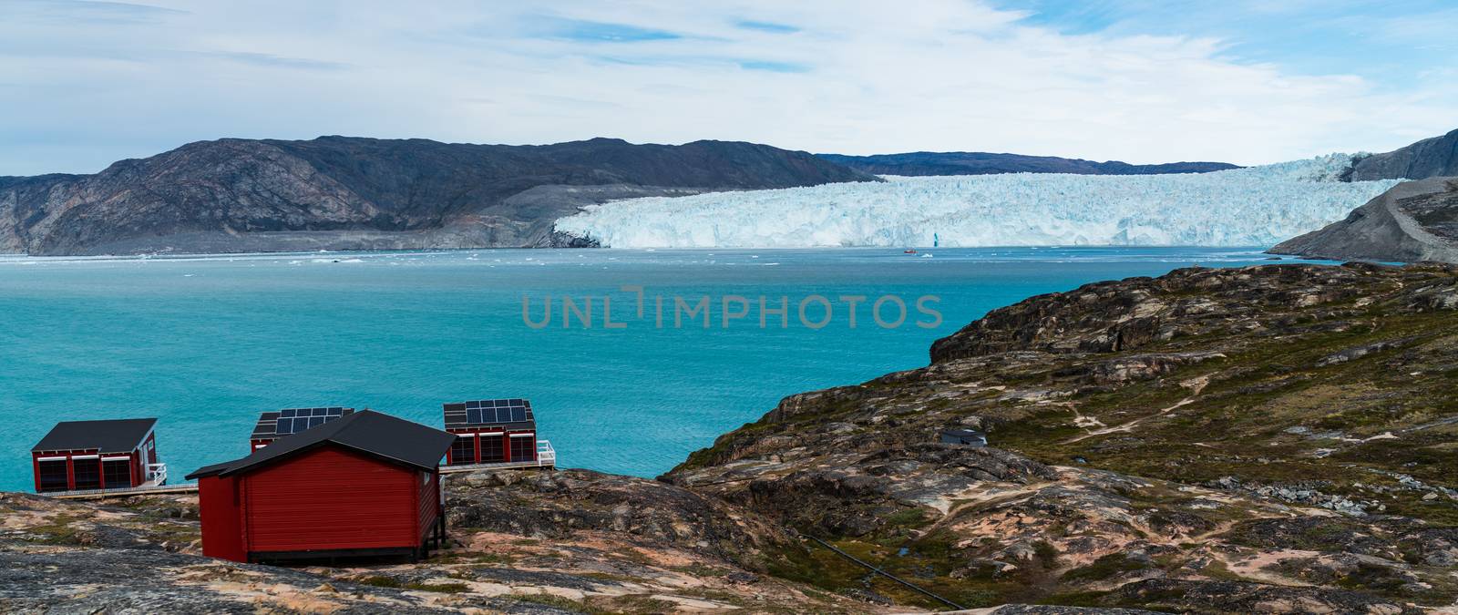 Greenland glacier nature landscape with famous Eqi glacier and lodge cabins by Maridav