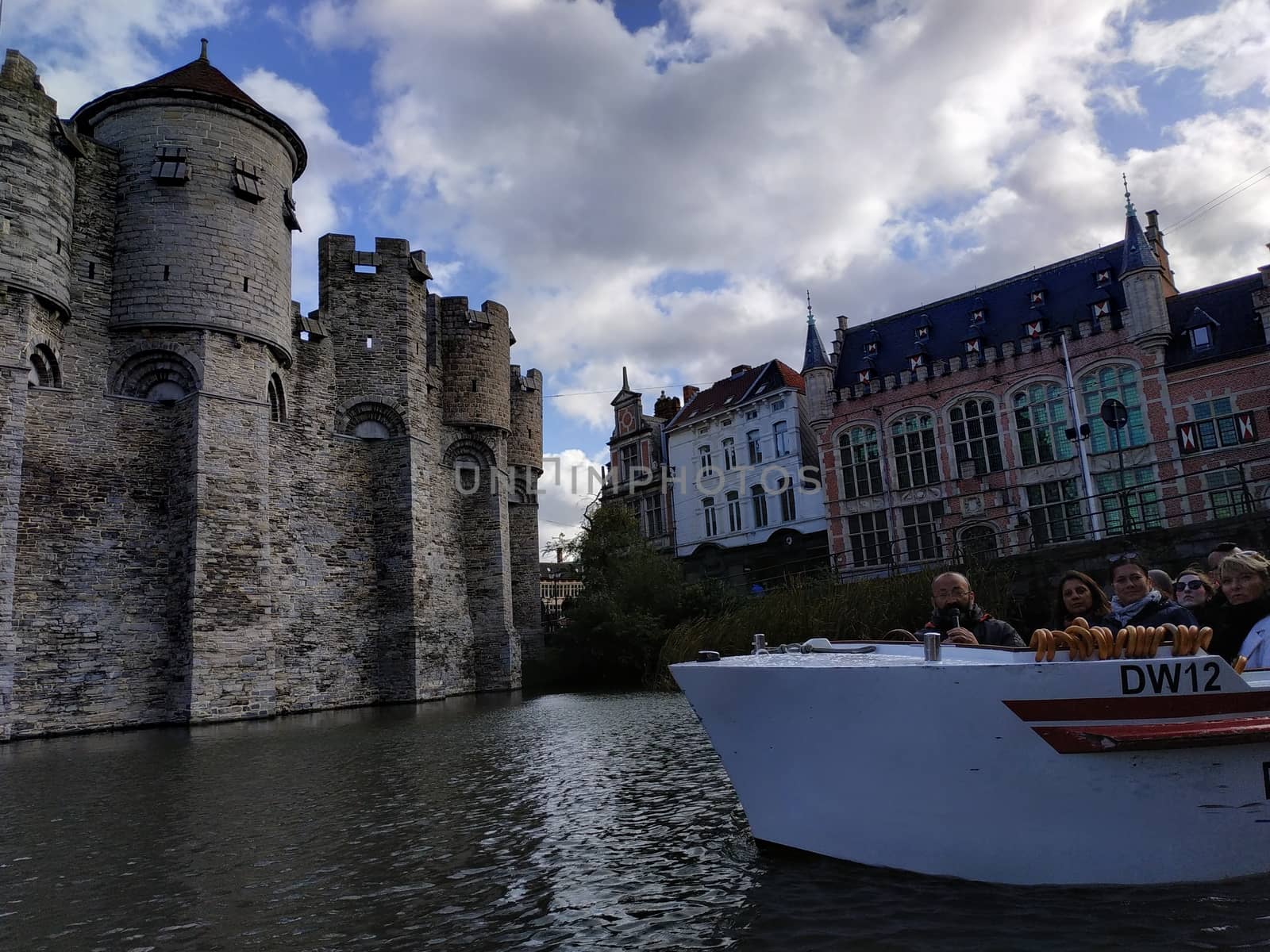 Ghent, Belgium - November 02, 2019: view on the streets and roads with tourists walking around by VIIIPhoto