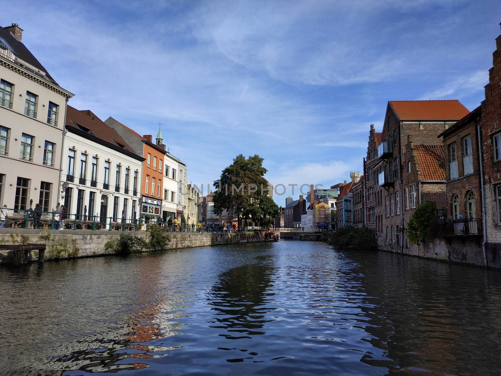 Ghent, Belgium casual view on the buildings streets and roads with tourists walking around by VIIIPhoto