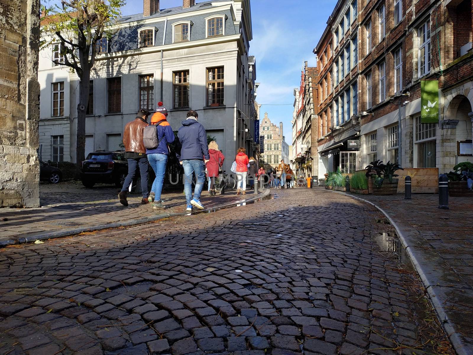 Ghent, Belgium - November 02, 2019: view on the streets and roads with tourists walking around by VIIIPhoto