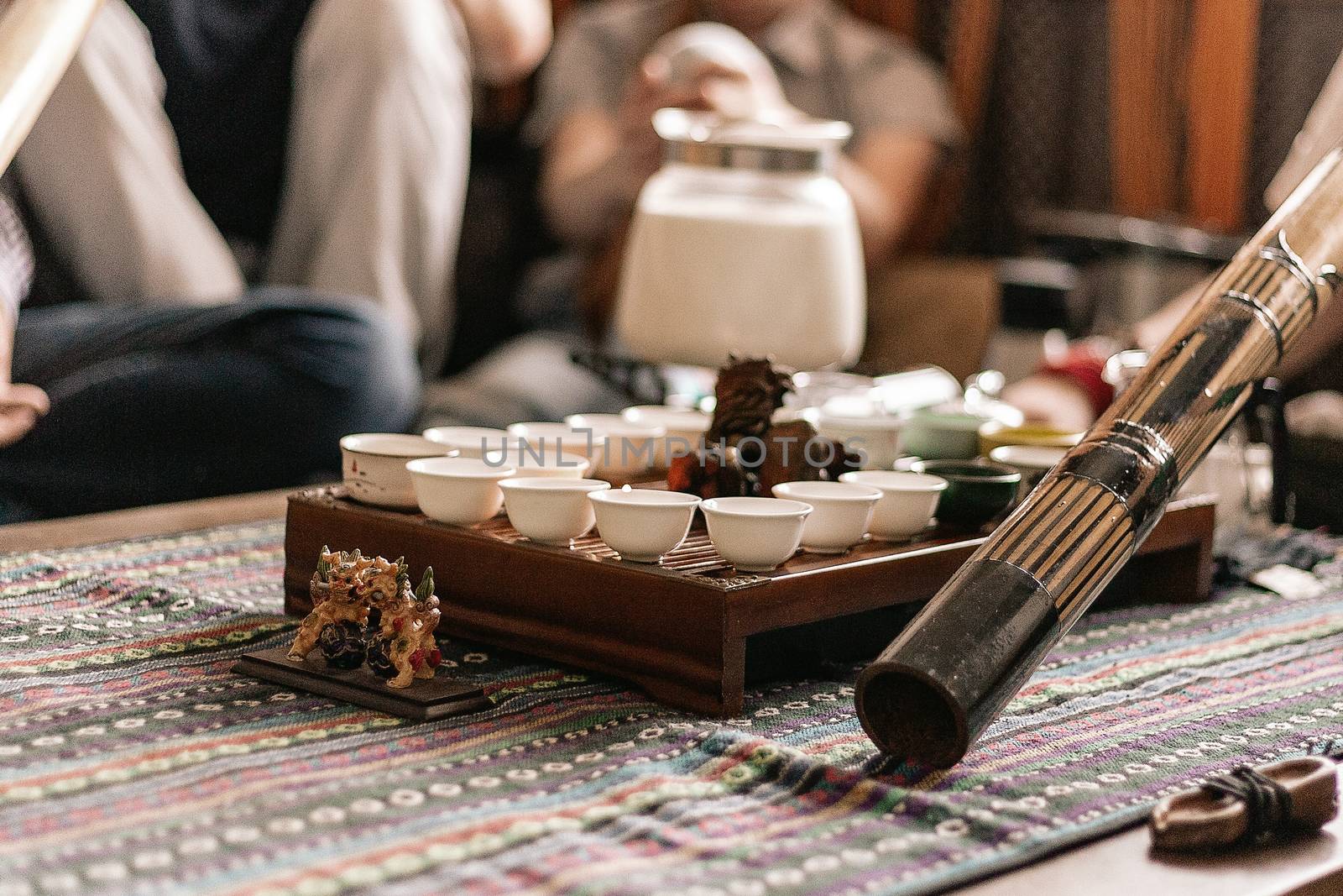 tea party in the style of boho, hippie. tea cups on a special wooden coffee table. Preparation of masala tea. a didgeridoo. Tea is prepared on the fire.