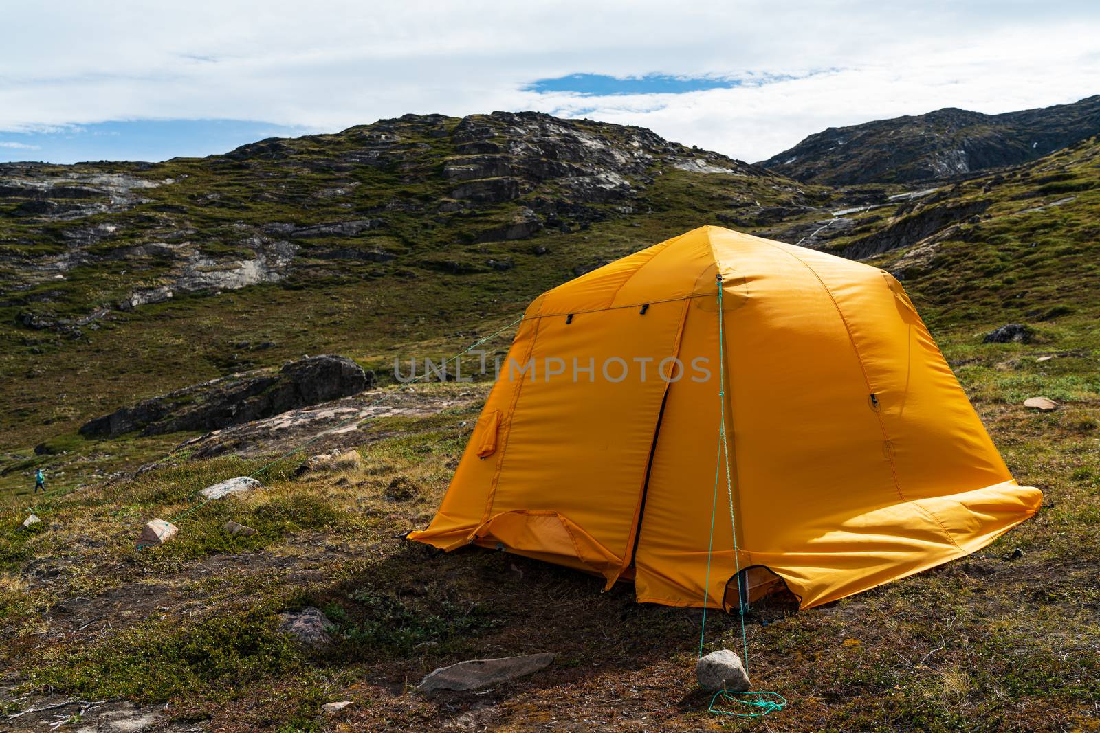 Tent camping in Greenland. Yellow tent pitched in West Greenland,