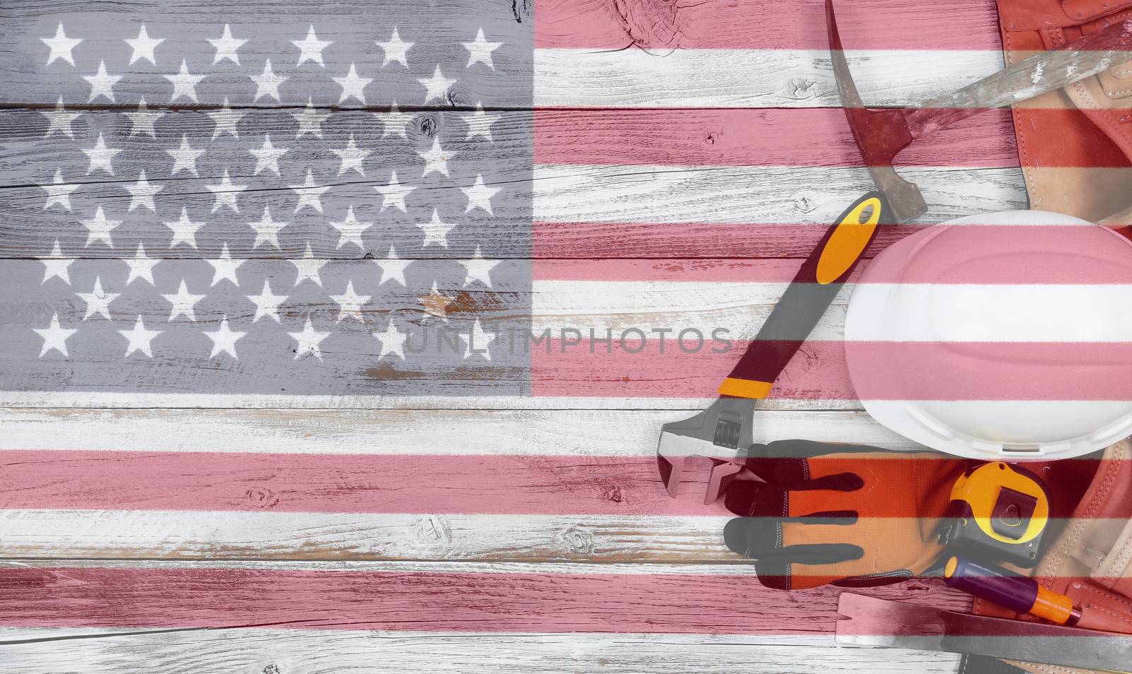 Labor Day concept with industrial worker tools over distressed white wooden boards with see through US Flag 