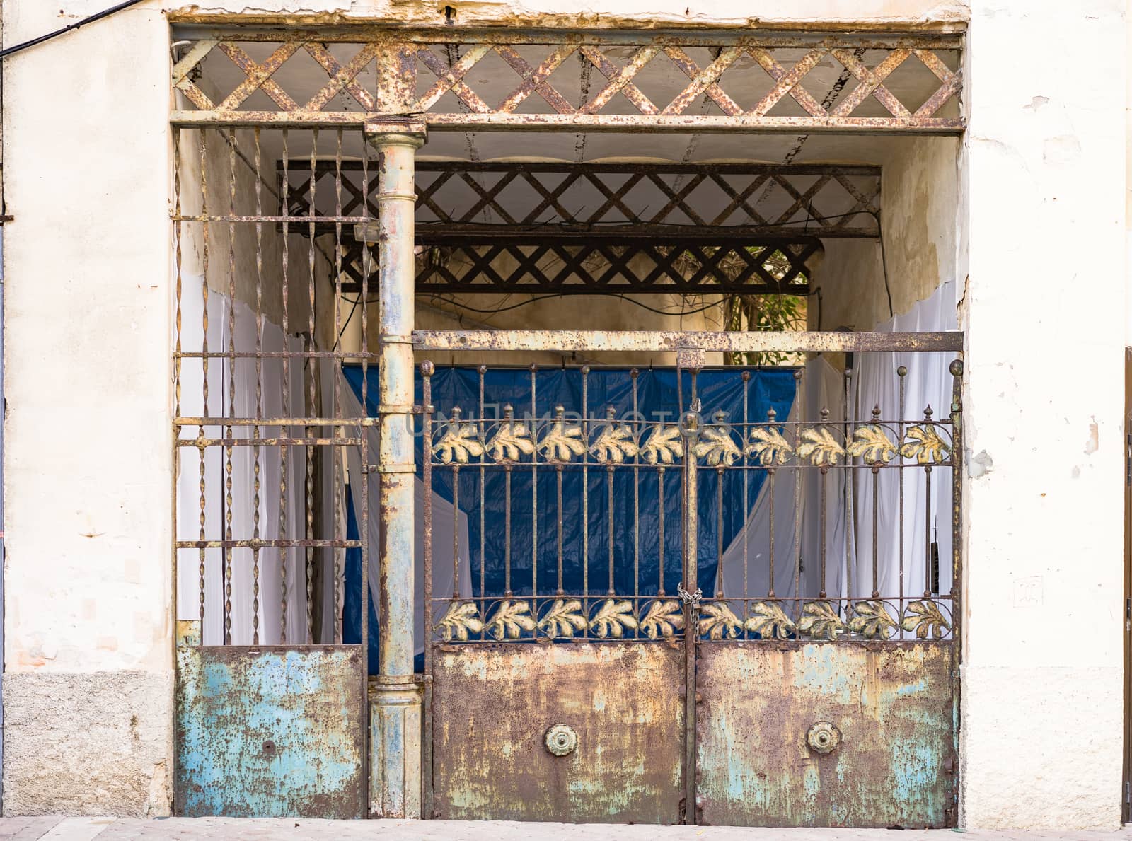 Closed vintage rusty metal gate 