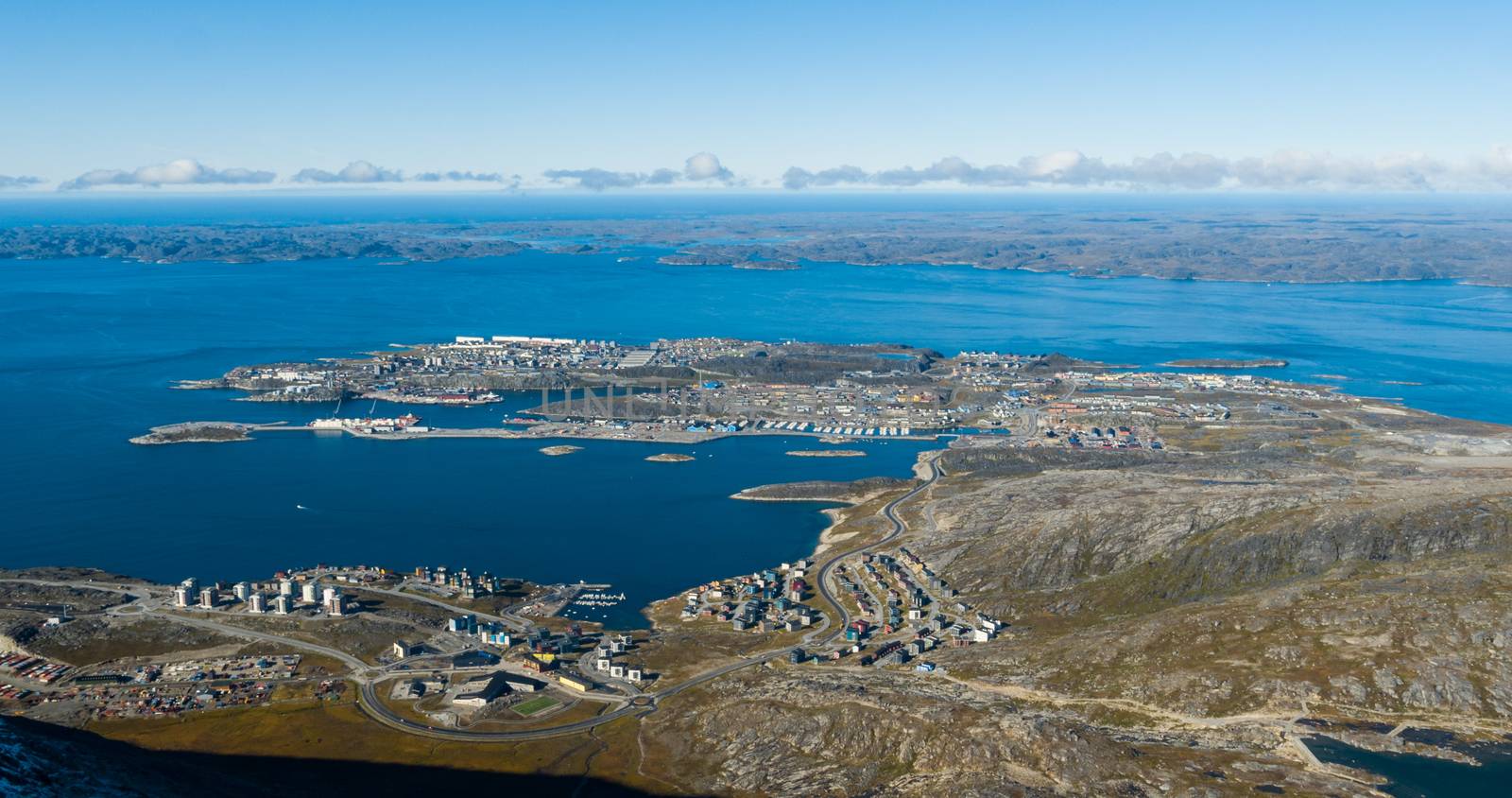 Greenlands capital Nuuk - largest city in Greenland aerial view. Drone photo of Nuuk from air, aka Godthaab seen from Mountain Sermitsiaq also showing Nuup Kangerlua fjord.