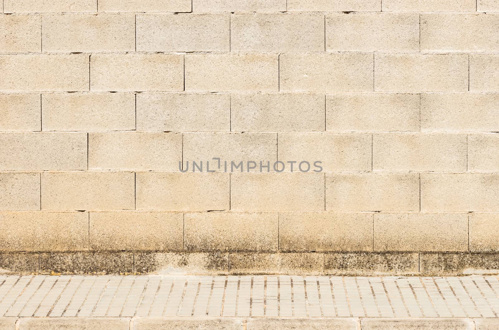 Urban old brick stone wall texture background with pavement