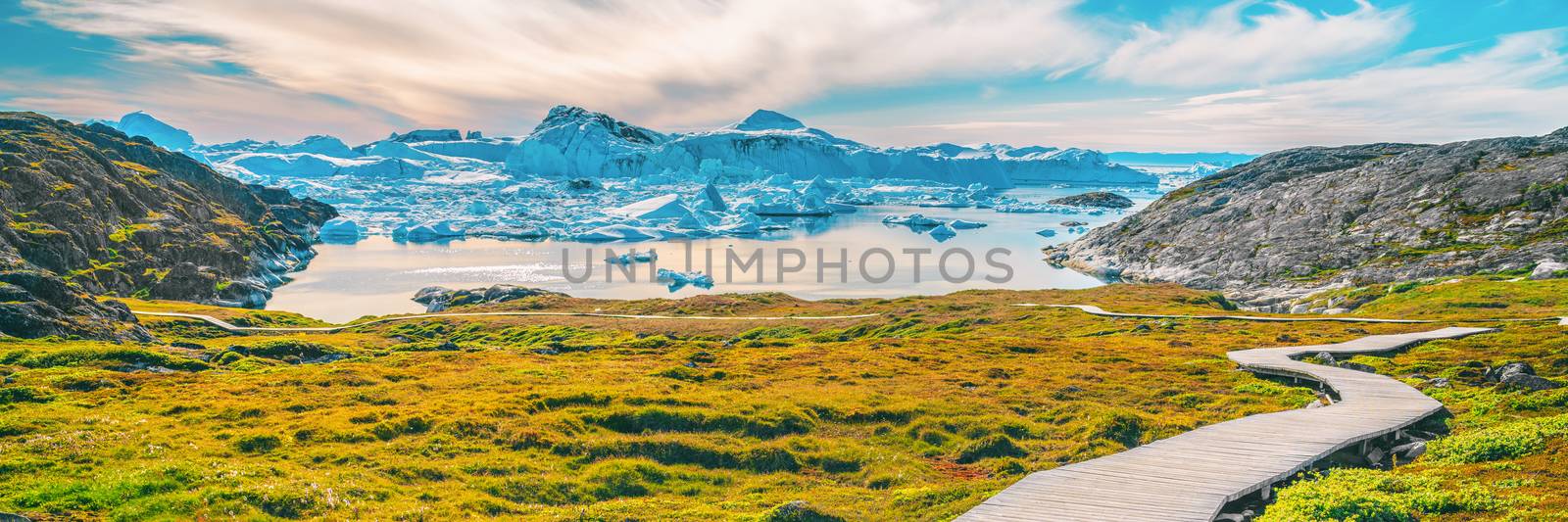 Hiking trail path in Greenland arctic nature landscape with icebergs in Ilulissat icefjord by Maridav