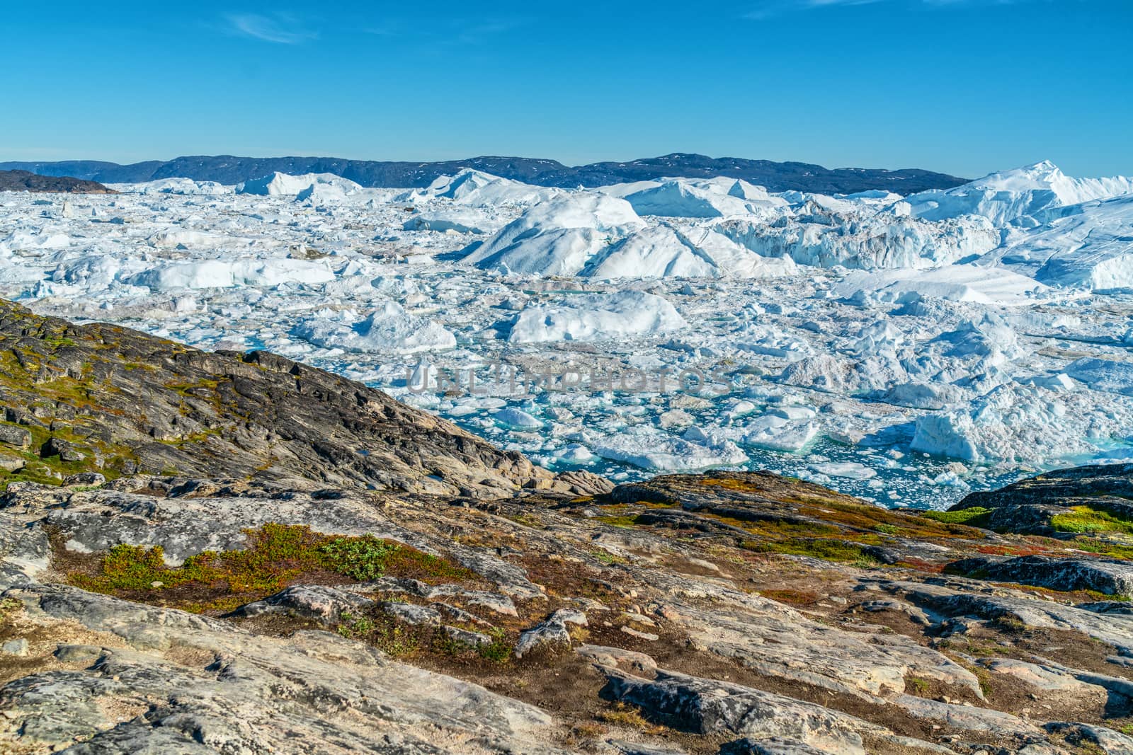 Icebergs from melting glacier in icefjord - Global Warming and Climate Change Icefjord in Ilulissat, Greenland. Aerial drone photo of arctic nature ice landscape. Unesco World Heritage Site.