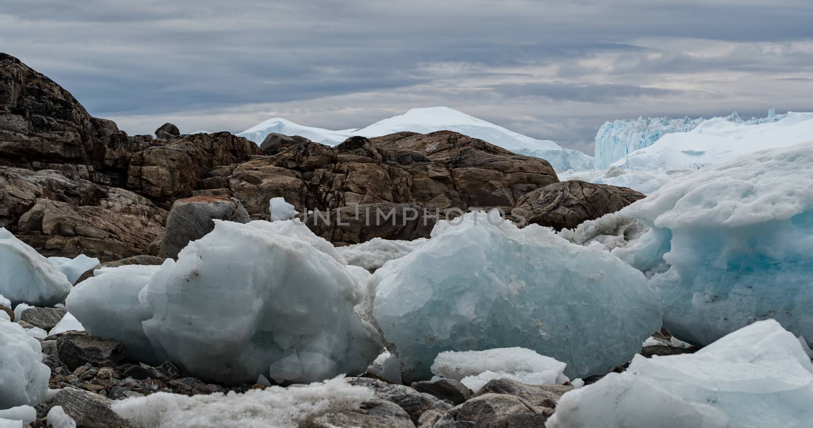 Iceberg and ice from glacier in arctic nature landscape on Greenland. Aerial drone image of icebergs in Ilulissat icefjord. Affected by climate change and global warming.