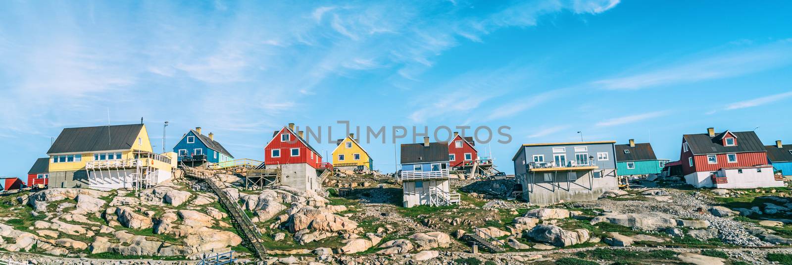 Greenland view of houses in Ilulissat City and icefjord. Tourist destination in the actic. Panoramic photo of typical Greenland village houses.