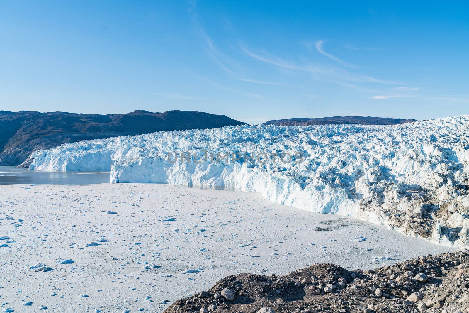 Greenland Glacier heavily affected by Climate Change and Global Warming. Glacier front of Eqi glacier in West Greenland AKA Ilulissat and Jakobshavn Glacier. Produces many of Greenlands icebergs.