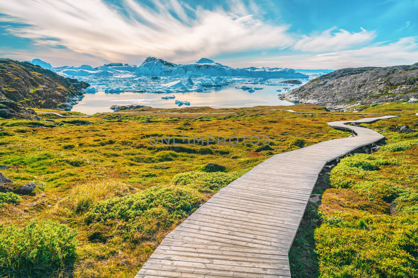 Hiking trail path in Greenland arctic nature landscape with icebergs in Ilulissat icefjord by Maridav