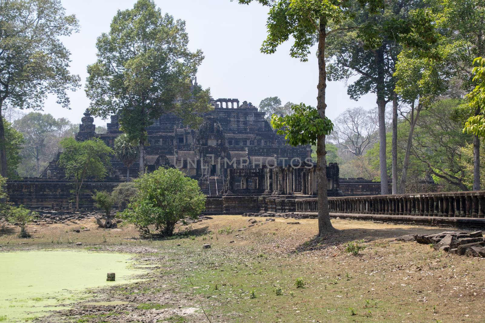 Angkor Thom, Cambodia, March 2016: Stone causeway supported by many finely carved columns, providing an impressive entrance to the Baphuon temple mountain.