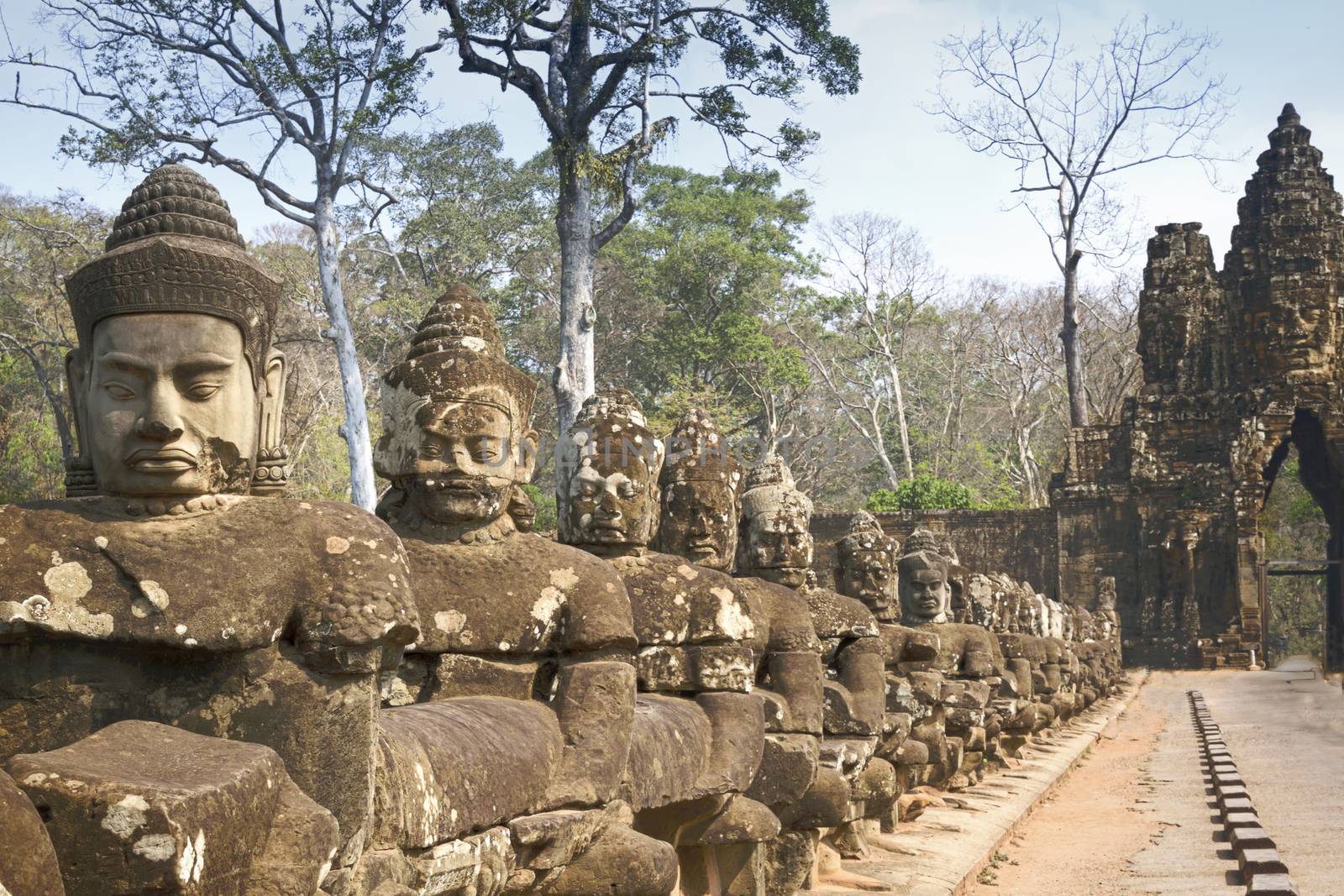 Angkor Wat Temple Cambodia - March 2018: Stone Asuras hold the nāga Vasuki on a bridge leading into the 12th century city of Angkor Thom. 