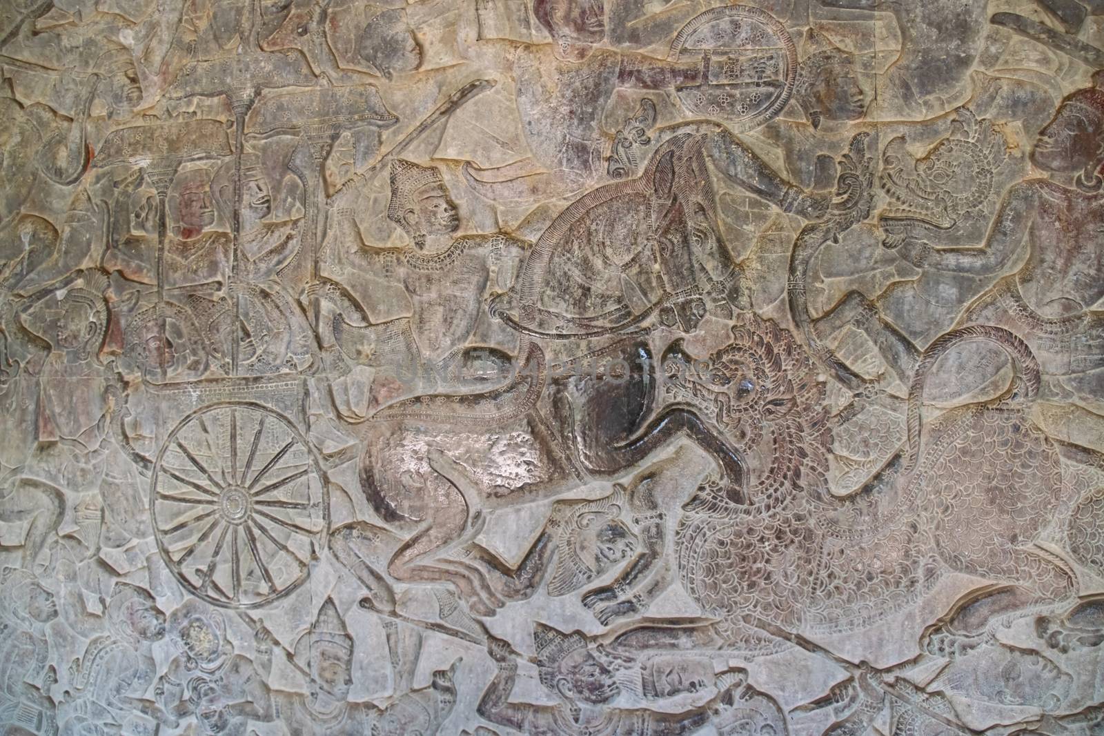 Angkor Wat, Cambodia - March 2016: Carved wall, depicting a warrior on horseback at Angkor wat. Originally constructed in the early 12th century, the ruins are a huge tourist attraction as well as a place of worship today