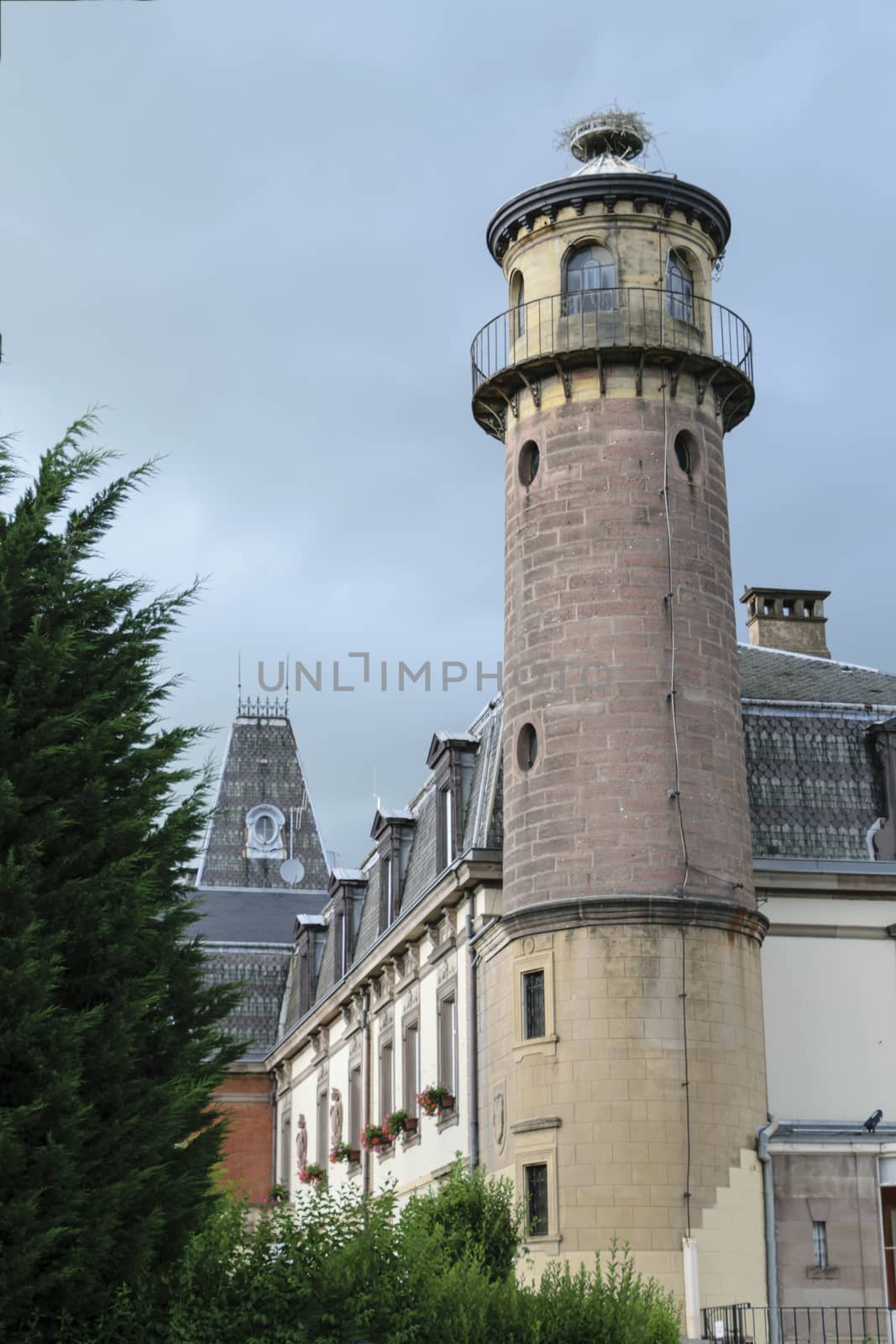 France, Alsace, June 2015: Stork nest on top of a chateau tower in Alsace France 