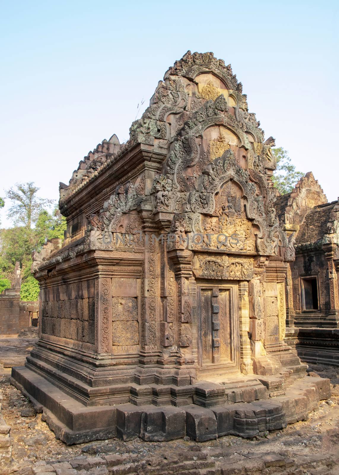 Cambodia, Banteay Seay - March 2016 - Reconstructed ruins of ornately carved 10th-century, red sand stone, temple dedicated to the Hindu god Shiva, bathed in the early morning light