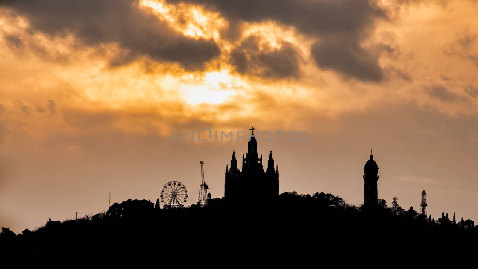 unset silhouette of Barcelona's Tibidabo Amusement Park by mrs_vision