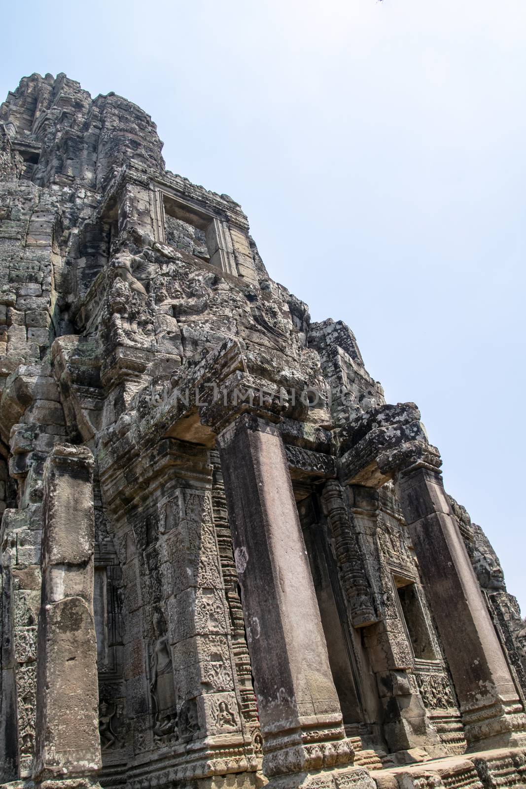 Cambodia, Bayon Temple - March 2016: Bayon is remarkable for the 216 serene and smiling stone faces on the many towers jutting out from the high terrace and cluster around the central peak